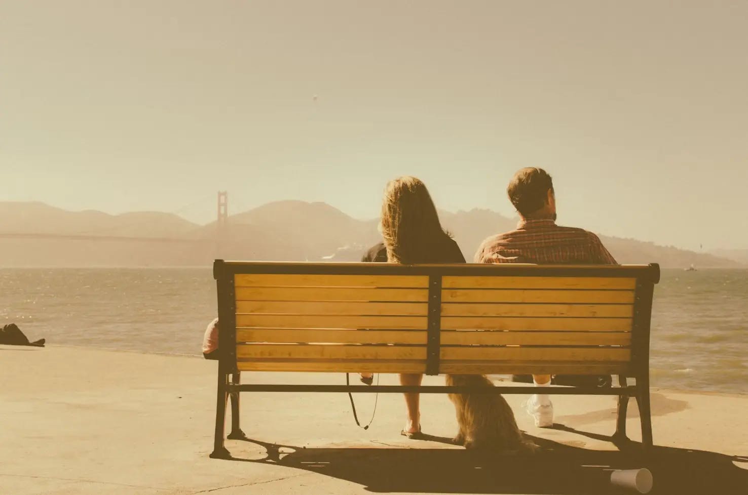 Couple sitting on a bench enjoying the river view