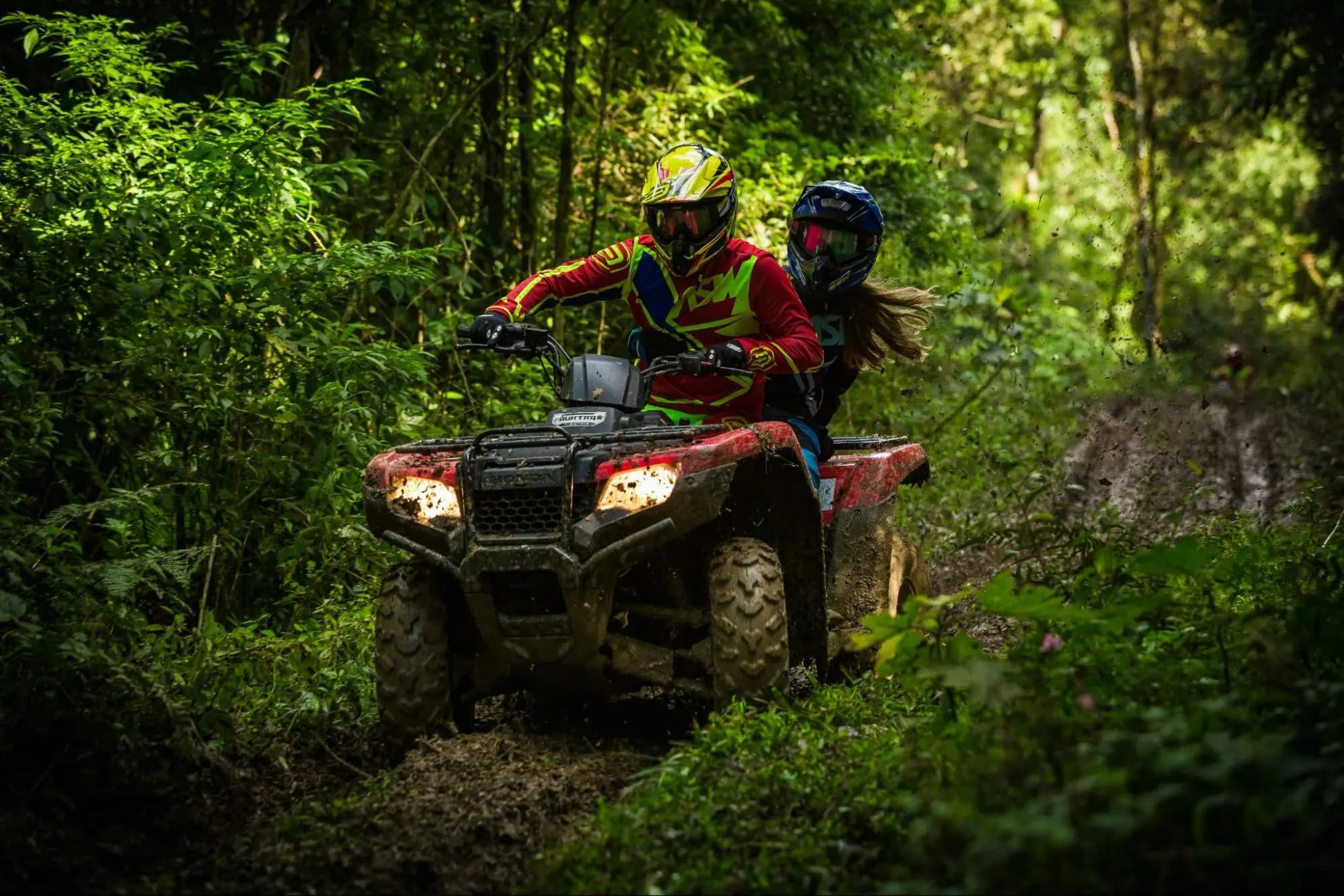 Couple riding a quad bike