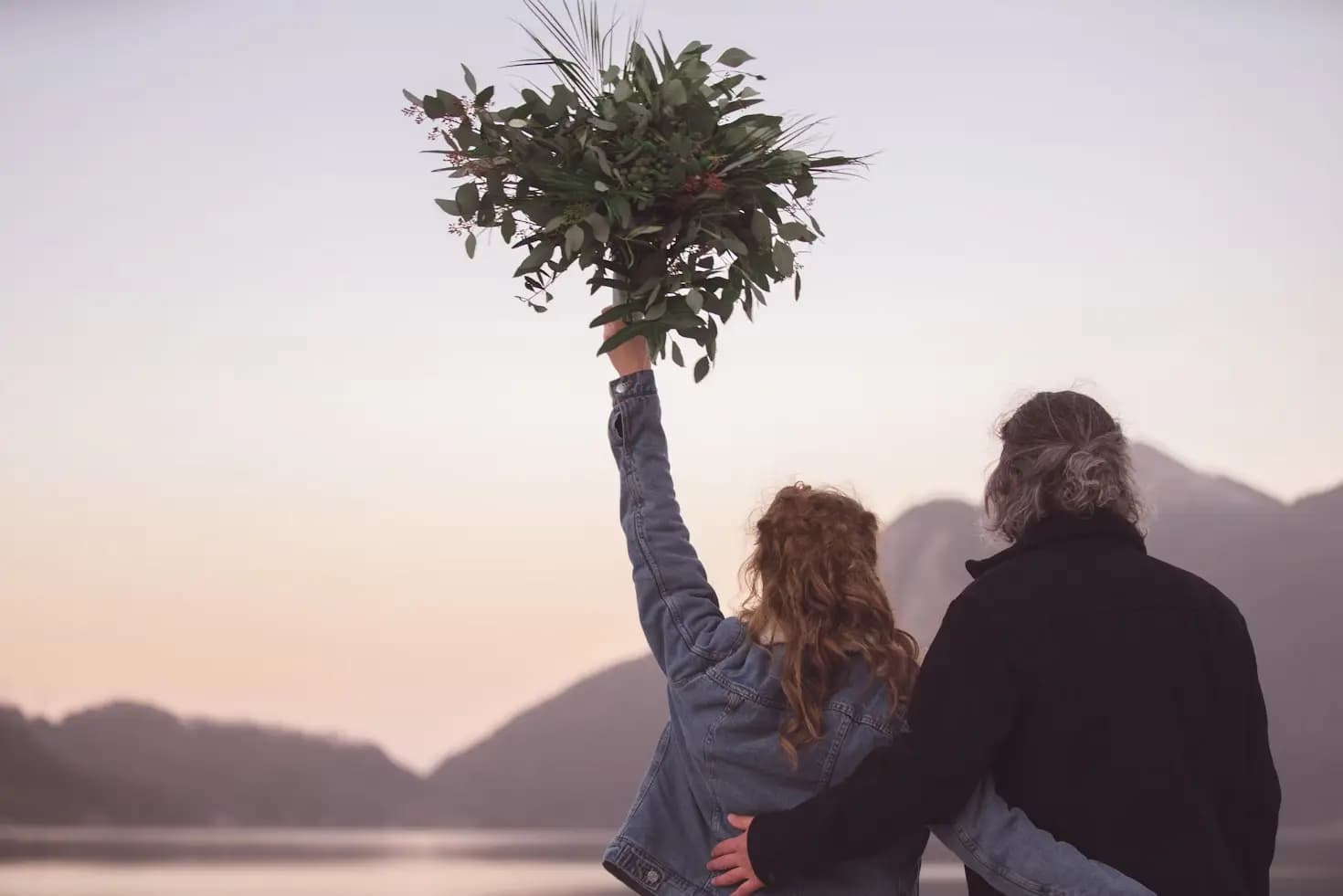 Girl holding a leafy bouquet overhead