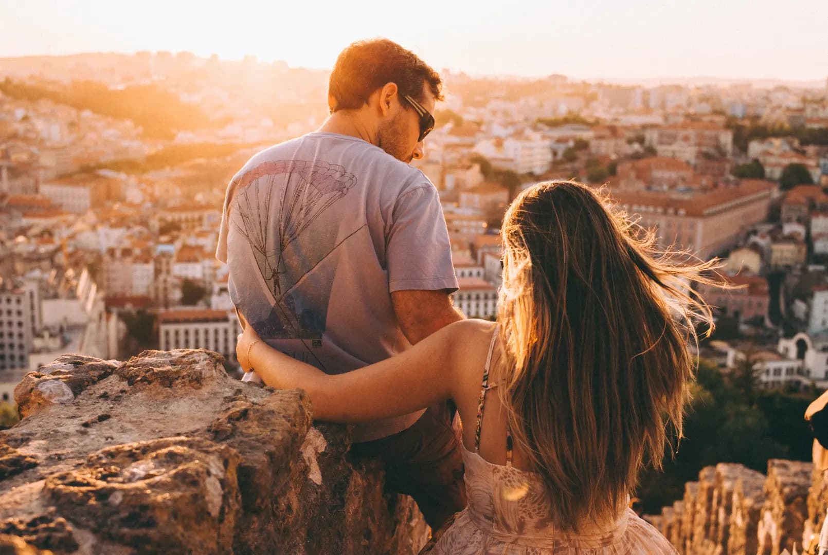 A couple is in a high place overlooking the town