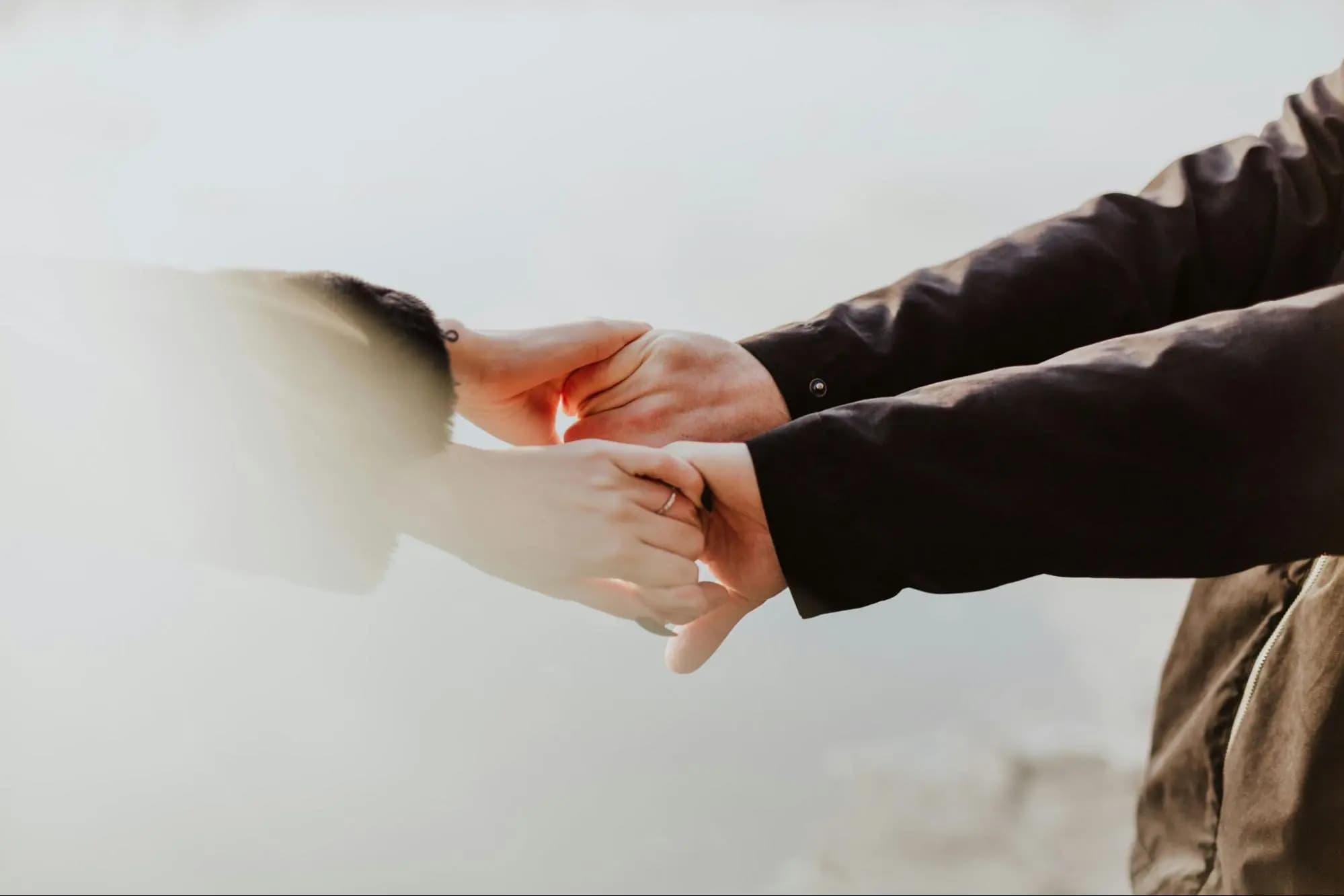 Close-up of a couple's hands clasped together