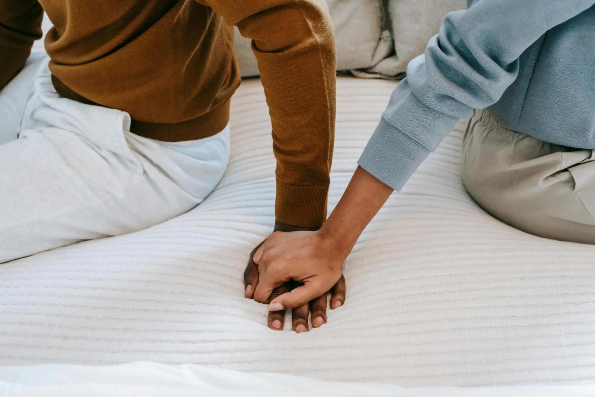 Girlfriend touching boyfriend's hand for comfort