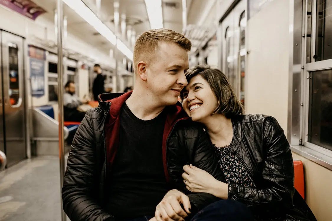 A couple sitting together on a train