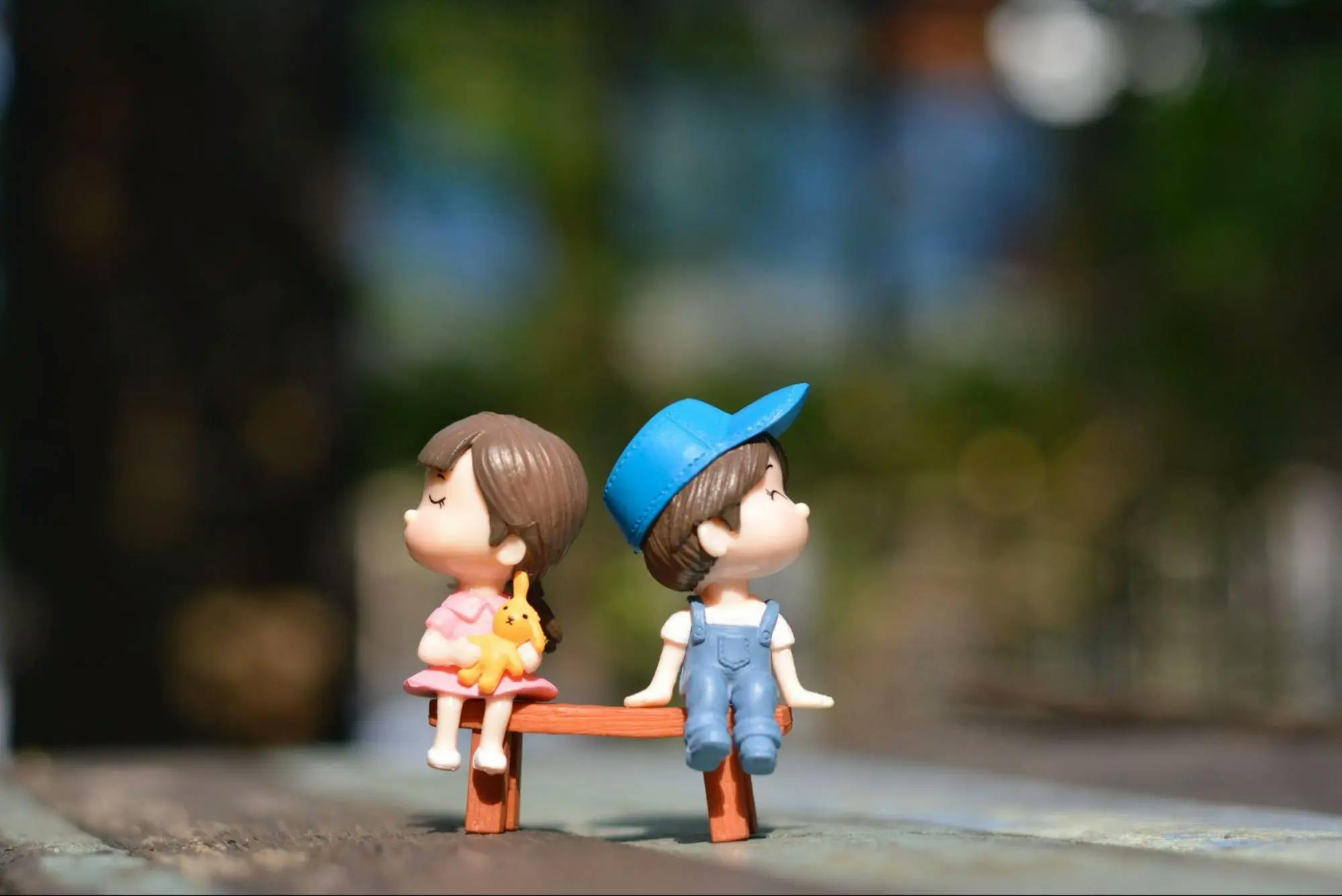 A figurine of a girl and a boy who are mad at each other