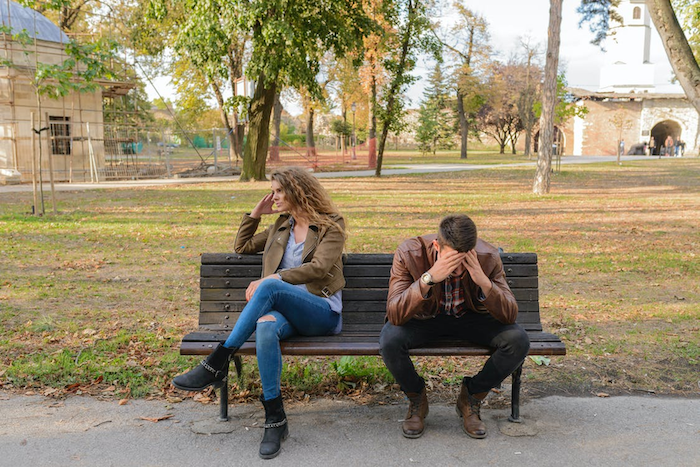 intj love - an upset intj couple sitting on a bench